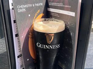 A pint of Guinness inside of a menu