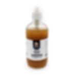 Clear bottle with white and black label amber liquid and white pump attachment