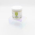 White jar with a white lid and white and green label sitting on a clear stand on a white background