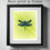 Thumbnail: A blue dragonfly digital painting on a green background printed on metallic paper and framed in a sleek black frame