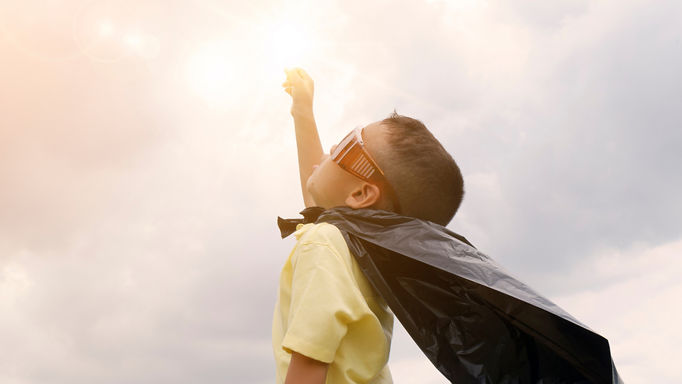 Boy in superhero cape soaring