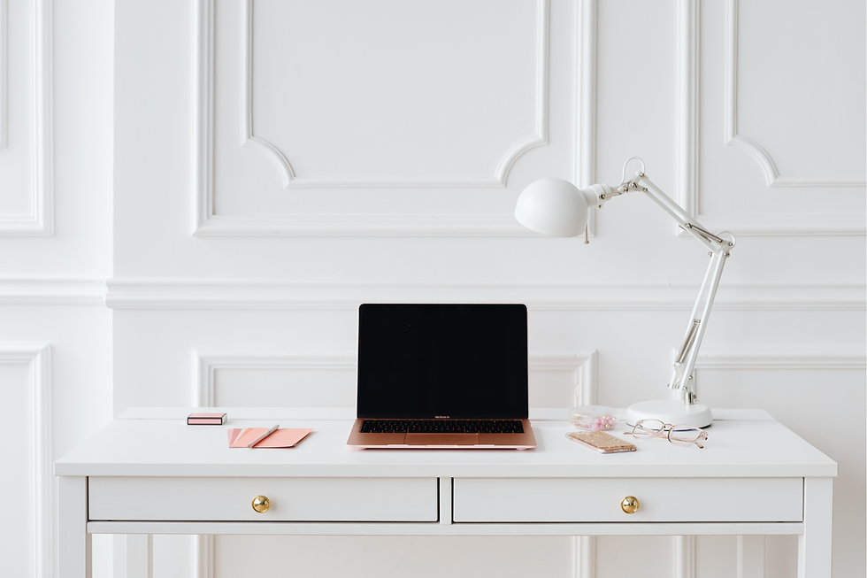 White desk with open laptop and lamp