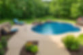 A high-resolution image showcasing a stunning custom pool with landscaping.