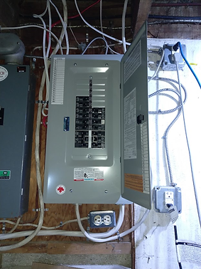 A gray electrical panel with open door revealing circuit breakers