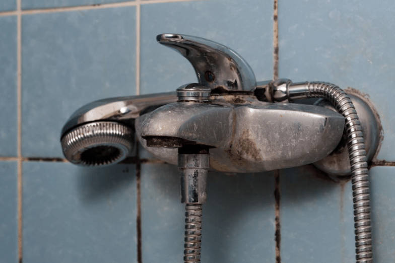 A close - up of a faucet that needs renovation