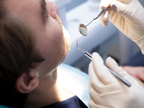 Dentist examining a patient’s tooth with dental instruments during an appointment