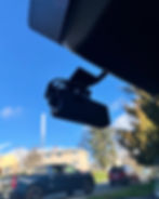 A dashcam is mounted inside a car windshield
