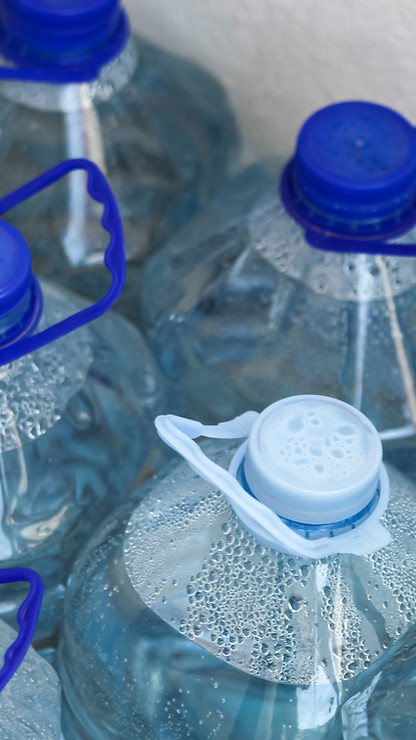 An overhead view of large plastic bottles of purified drinking water