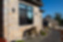 Modern house exterior with stone facade and large window