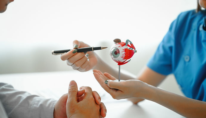 Doctor explaining about eye to a patient using a plastic eye ball