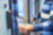 A person uses a keycard to unlock a glass door