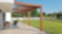 Spacious backyard with a wooden pergola over a patio