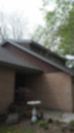 A picturesque brick house with a lovely bird bath