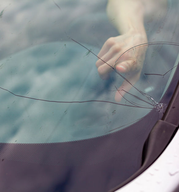 Cracked front windshield after stone chip on the road