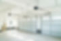 Spacious, bright garage interior with two white double-door garages