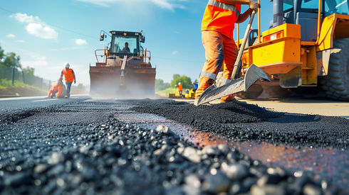 Construction workers in orange vests smooth fresh asphalt