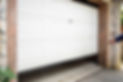 A partially open white garage door