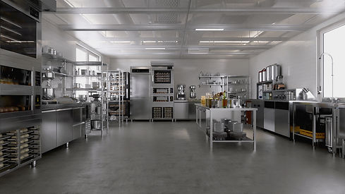 Clean commercial bakery kitchen with stainless steel equipment