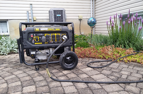 A generator sits on a cobblestone patio