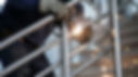 A welder welding stainless steel handrails for a luxury hotel staircase