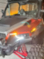 Red and black off-road vehicle inside a garage