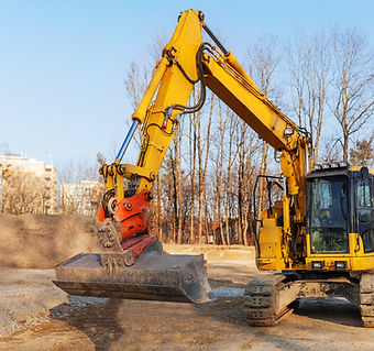 Yellow excavator with large bucket on dirt construction site