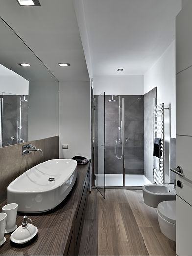 Stylish bathroom with walk-in shower and wood floor