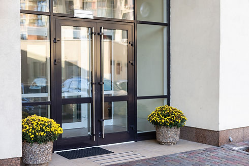 Modern glass entrance with black metal frames