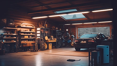 A sleek black car is parked inside a dimly lit garage