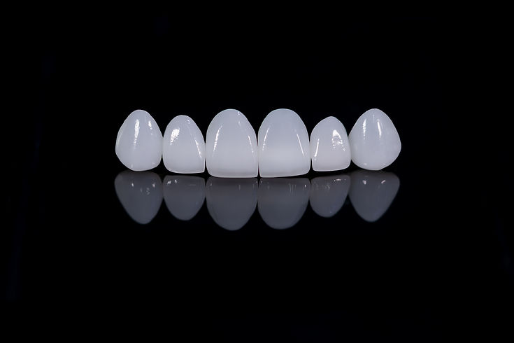 A striking image featuring a set of white teeth against a contrasting black background