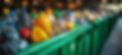 A closeup view of a crate or container filled with various colorful recycled plastic and glass bottles