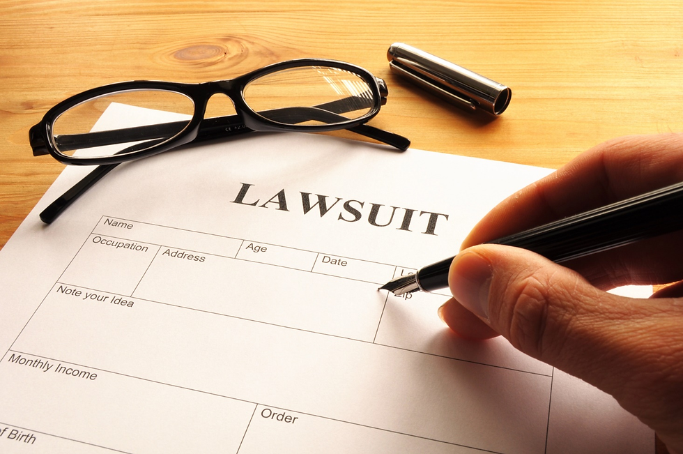 A lawsuit form displayed alongside a pen and a pair of glasses, symbolizing legal documentation and preparation