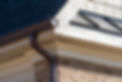 Closeup view of dark brown gutter system with white soffit vent