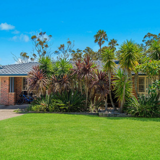 Brick home with palms out the front in Port Macquarie region
