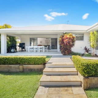 Coastal white home over looking garden and sandstone steps at Coffs Harbour