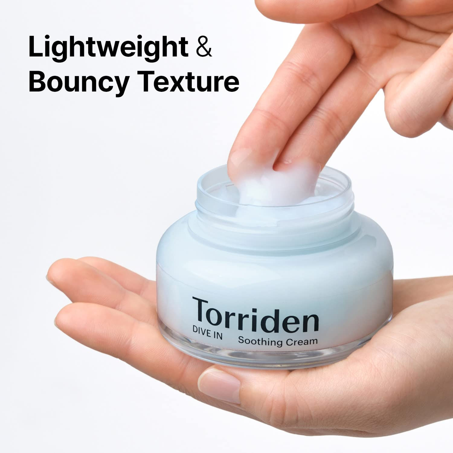 woman taking out Torriden - Dive-In Hyaluronic Acid Soothing Cream out of the jar showing its lightweight and bouncy texture