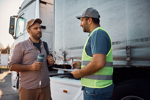 young-truck-driver-talking-to-a-dispatcher-on-park-2024-12-13-18-32-11-utc.jpg