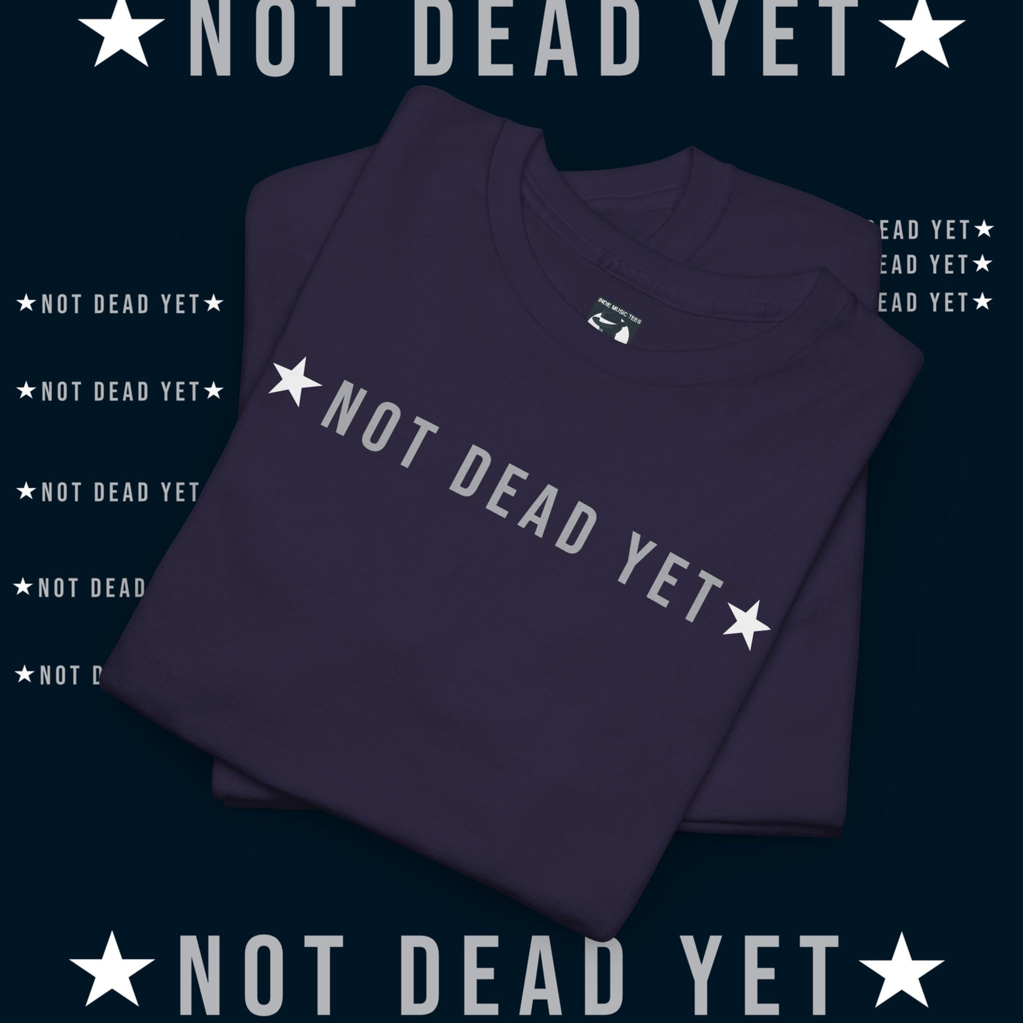 Not Dead Yet text on a purple t-shirt. 1976 Unisex Premium Long Sleeved tshirt.