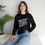 Thumbnail: Woman wearing black sweatshirt with white text reading 