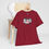 Thumbnail: Product: 1976 Unisex tshirt red hanging from a chair