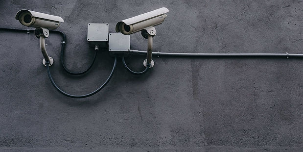 a photo of cctv cameras on a gray wall in Michigan