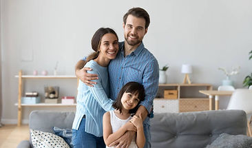 a photo of a family smiling inside their house