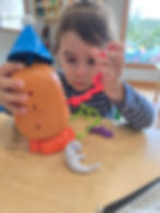 Toddler playing with a toy at Greenfield WI daycare.