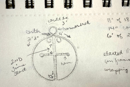 A drawing of a cross necklace design