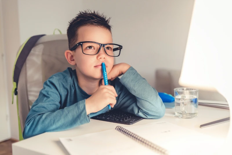 Young boy thinking about homework