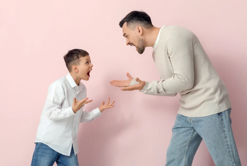 Dad and young son shouting at each other