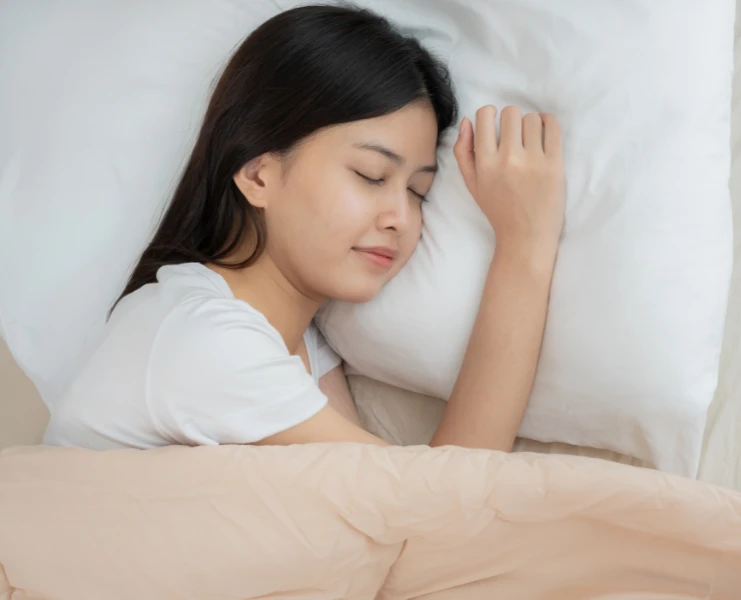 Young girl sleeping, head on her pillow