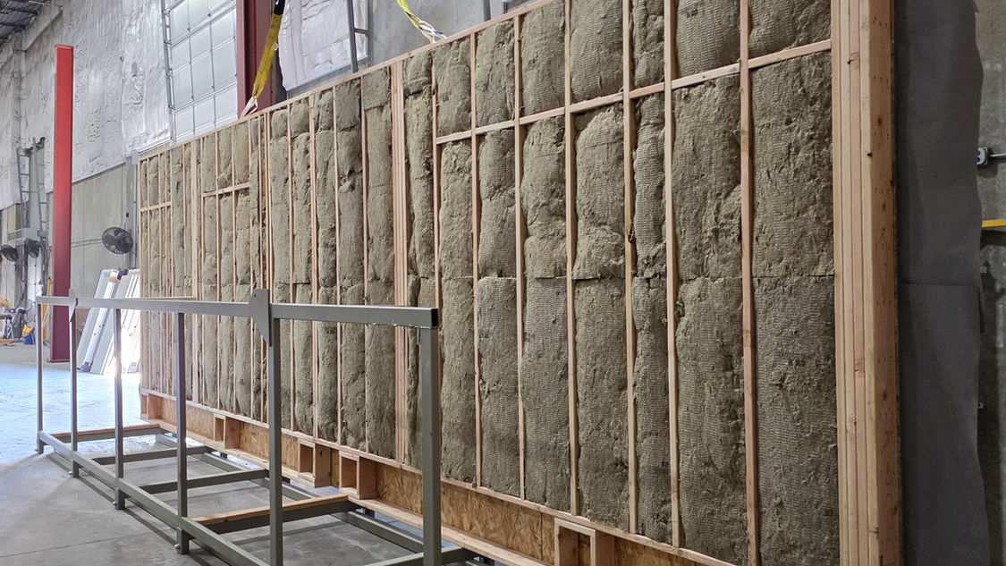A framed wall panel with cavity insulation installed, standing in the storage rack at the MBS plant in St. Louis