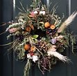 Christmas wreaths on a black door in Lon