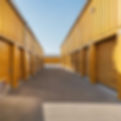 self storage units with a muted mustard yellow exterior view from an angle.jpg